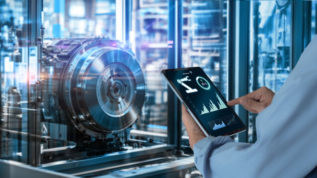 Smart industry automation manufacturing control concept.Hands holding tablet on blurred automation machine as background.. - Powered by Adobe