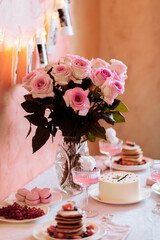 Festive table setting with pancakes, cocktails, cotton candy in pink tones