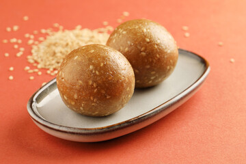 Sesame seed jaggery ball or til ke laddo and tilgul or til gul laddu served in bowl for Makar Sankranti Festival in India