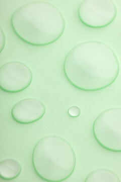 Close-up of droplets on a light green surface background