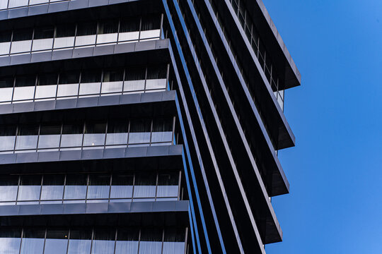 Close-up view of a modern skyscraper's geometric facade - Powered by Adobe