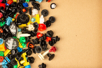 Close-up of plastic colored clips for car.Abstract background. Panel plastic rivets, Auto plastic clips.