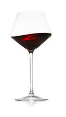 Red wine splashing in glass on white background