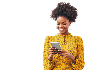 Confident woman in a yellow blouse holding a tablet and a phone, smiling naturally. Isolated on a white transparent background, ideal for tech and lifestyle themes.

