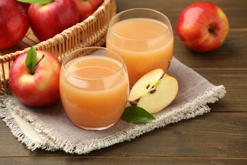 Tasty apple juice and fresh fruits on wooden table, closeup