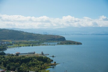 Tranquil lake with greenery and mountains in Kunming.