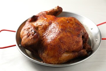 Delicious baked turkey in baking dish on light table, closeup