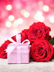 A romantic Valentine's Day setting with a pink gift box, red roses, and a glowing bokeh background, radiating love and celebration. Generative AI