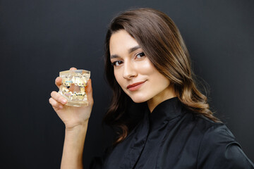 Orthopedic dentist doctor is holding teeth 3d printed model of the patient's jaw with malocclusion