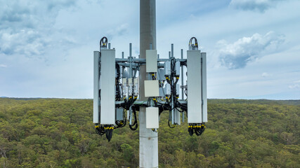 Drone aerial photograph of the bottom section of a telecommunications tower equipped with antennas and transmission equipment used for communications in regional New South Wales, Australia.