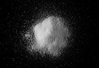 Pile sea ​​salt grains, crystals isolated on black background, top view