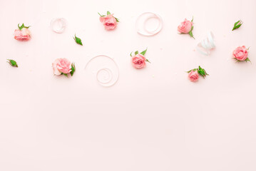 Roses buds on soft pink background, women's day border, mother's day backdrop, natural floral frame. Romantic wallpaper.Wedding decor.