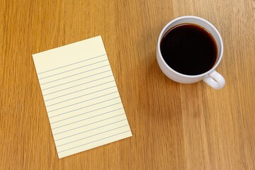 Office desk or table with notebook and cup of coffee, flatlay