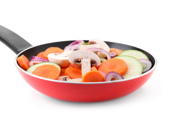 Frying pan with mix of fresh vegetables and mushrooms isolated on white
