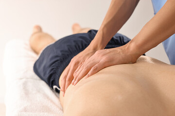 Fototapeta premium Professional physiotherapist doing back massage for his client indoors, closeup