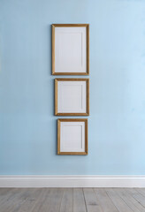 empty picture frames on blue wall