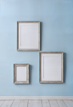empty picture frames on blue wall