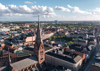 Summer skyline cityscape of Central Malmö, Sweden at sunset. Sankt petri kyrka and Stortorget square in the foreground