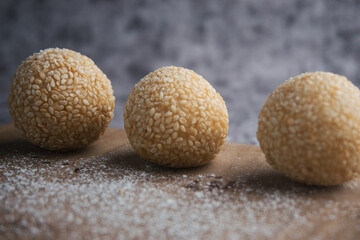 Close-Up of Sesame Balls with a Rustic Wooden Background