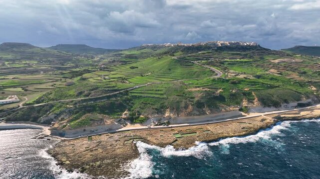 4k Aerial view of Salt flats showcase intricate patterns and vibrant colors under bright sunlight in island Gozo. Malta