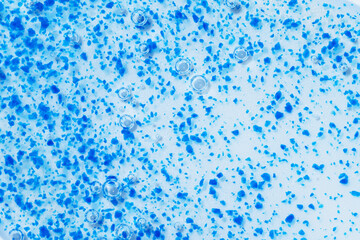 Texture of face scrub with blue micro-exfoliating particles