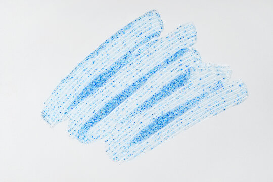 Smooth white cream texture with blue exfoliating particles