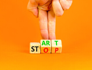 Start or stop symbol. Concept words Start or Stop on beautiful wooden block. Beautiful orange table...