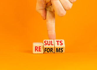 Reform and result symbol. Concept words Reforms Results on beautiful wooden block. Beautiful orange...