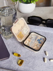 A small female pillbox is lying on the table