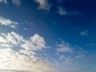 A beautiful sky showcasing fluffy clouds against a vibrant blue backdrop, perfect for serene and peaceful imagery.
