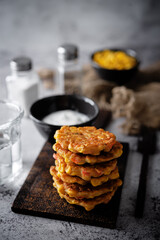 Corn and potato fritters with sour cream sauce