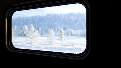 Fototapeta premium A winter view from a train window with a beautiful winter view, the feeling of moving in the picture. Generative AI