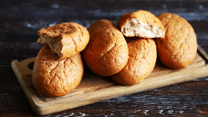 Fresh bran buns on a board