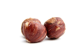 Detailed view of whole hazelnuts showcasing their rich brown shell textures. Isolated on a white background, ideal for natural food concepts