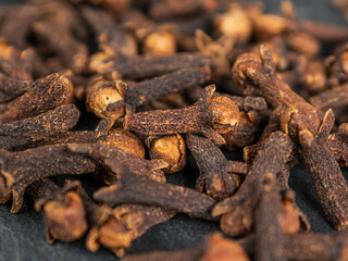 A close-up of aromatic cloves, highlighting the texture and rich color