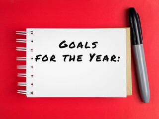 goals for the year text on notepad page colored background
