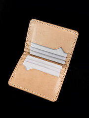 Blank brown open men's leather wallet, contains various plain cards isolated on black background, perfect for leather industry catalog design