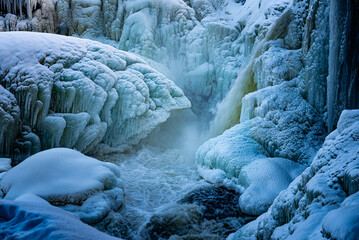 Ice, icicles and snow in waterfall Ristafallet in Sweden January 2025.