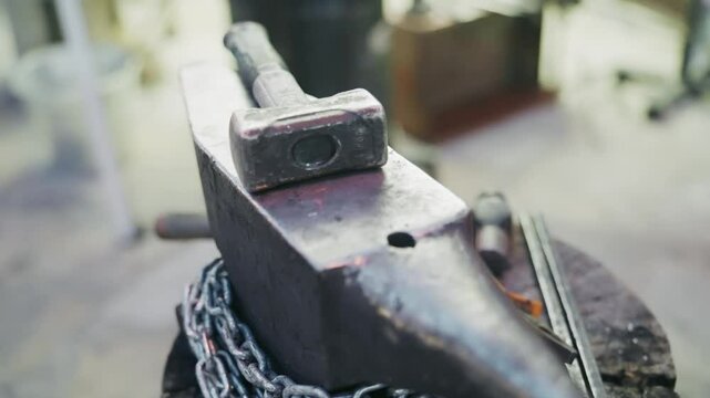 Traditional blacksmith tools with a hammer and anvil in a workshop