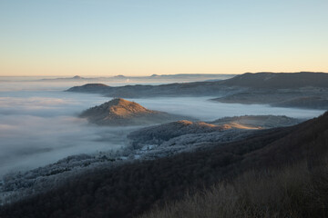 Blick vom Breitenstein, Ochsenwang, Schwäbische Alb auf die drei Kaiserberge - Hohenstaufen, Stuifen und Rechberg. Im Vordergrund die Limburg bei Weilheim Teck im Winter zum Sonnenaufgang mit Nebel.