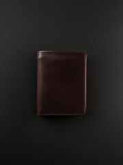 Blank brown men's leather wallet isolated on black background, perfect for leather industry catalog design
