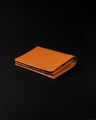 Blank brown men's leather wallet isolated on black background, perfect for leather industry catalog design