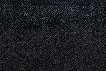 Closeup view of black door mat. Seamless pattern of black carpet