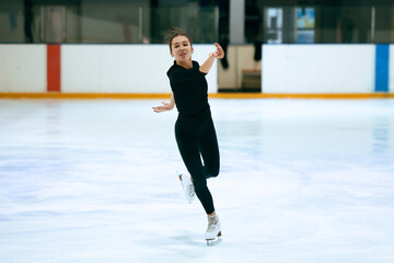 Girl figure skater trains on skates on the ice.