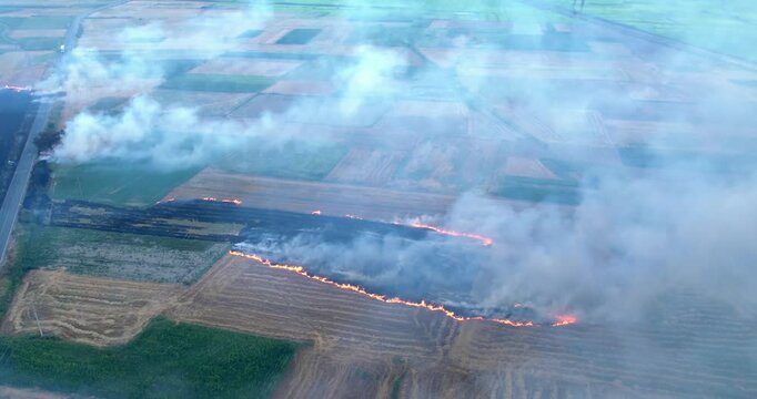 Sky with smoke from burning agriculture bush fields in the background, aerial view