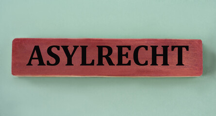 Obraz premium ASYLRECHT - word on brown wooden block on mint background