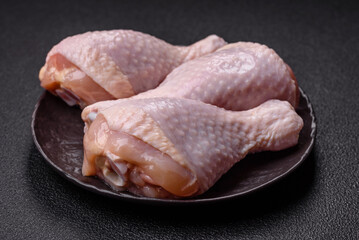 Raw chicken legs with salt, spices and herbs