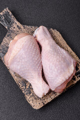 Raw chicken legs with salt, spices and herbs