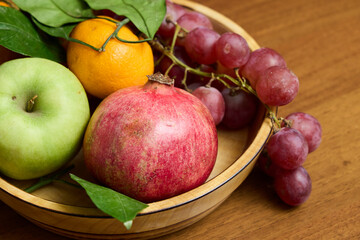 A Colorful Assortment of Fresh, Ripe Fruits Arranged Vibrantly in a Beautiful Wooden Bowl