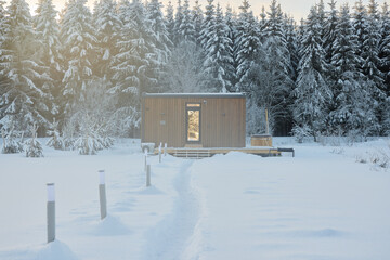 A Serene and Cozy Winter Cabin Nestled in a Picturesque Snowy Landscape Surrounded by Nature